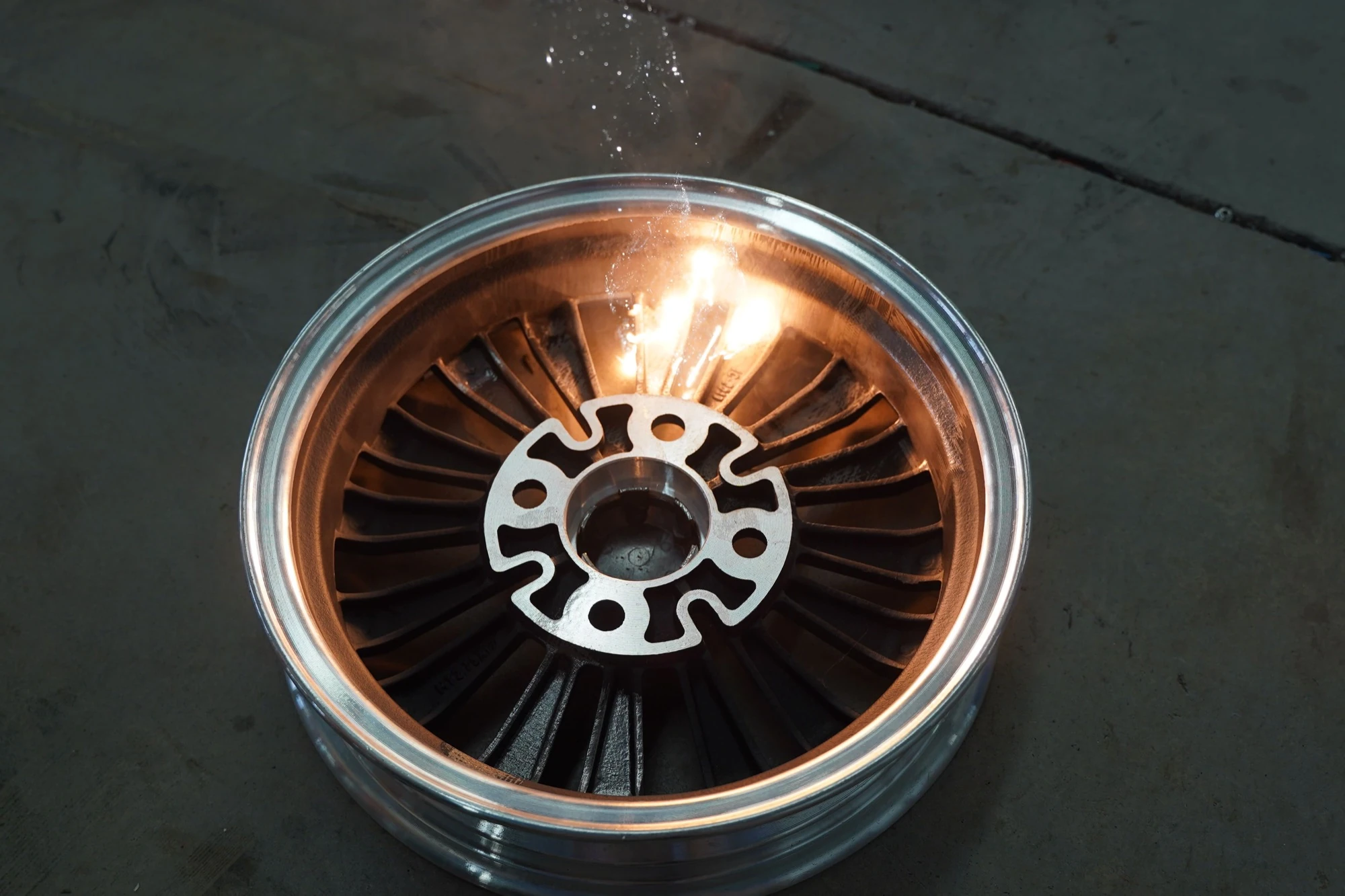 High-power laser cleaner removing corrosion from a heavy metal part